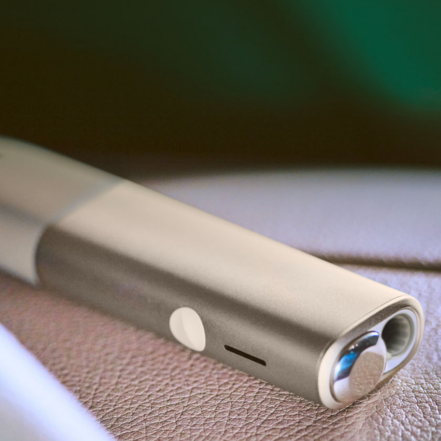 An IQOS ILUMA device and mobile phone.